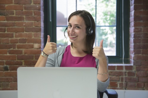 woman at computer with thumbs up