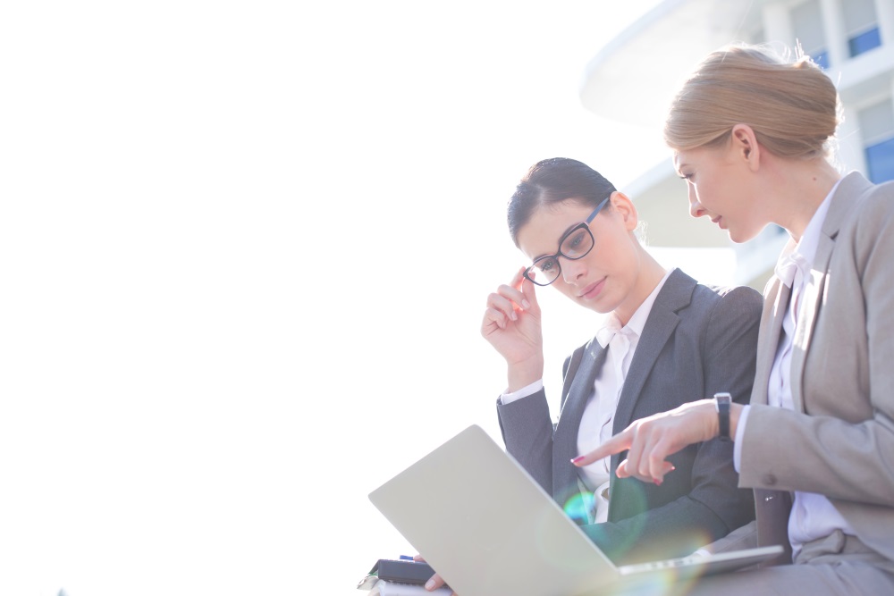 two women looking at a laptop