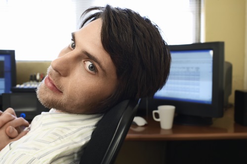 man sitting at computer