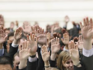 people raising their hands to say they are interested in writing a book