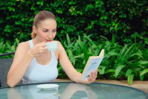 woman reading book outside