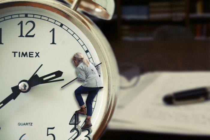 woman holding clock hands