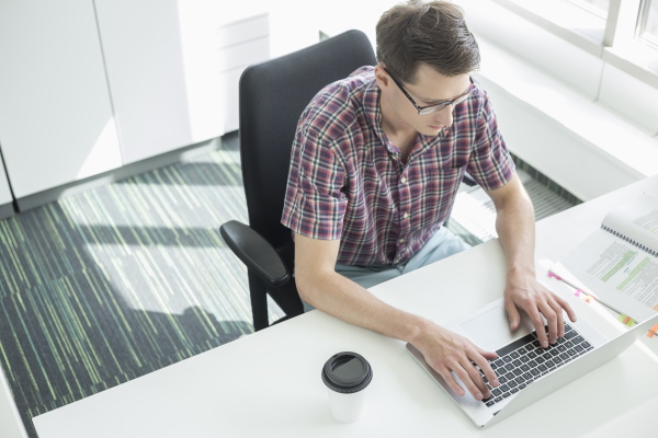 man at computer using a pro aid for writing
