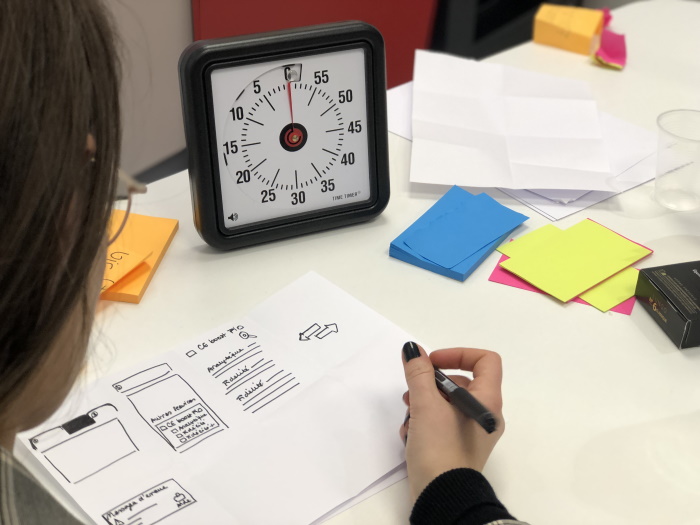 woman with pen in hand thinking writing is so hard