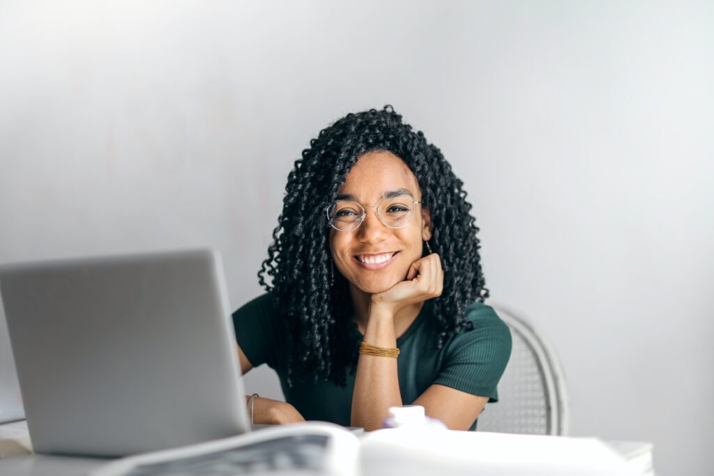 Happy Lady sat at computer smiling