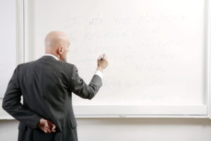 teacher at blackboard
