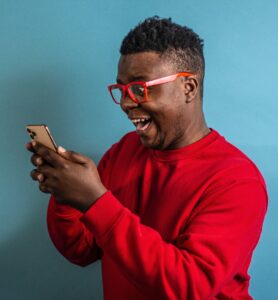 man looking happy at phone