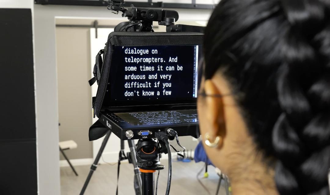 woman recording a video using a teleprompter
